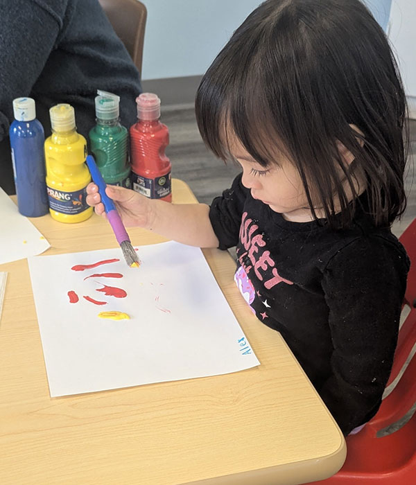 a girl is painting a picture