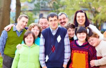 group of happy people with disabilities, outdoors